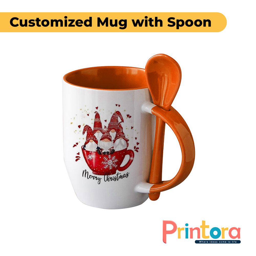 A white ceramic customized mug featuring a personalized photo print and a matching colored spoon inserted into the handle. The mug has a glossy finish and is designed for gifting and everyday use in Pakistan.