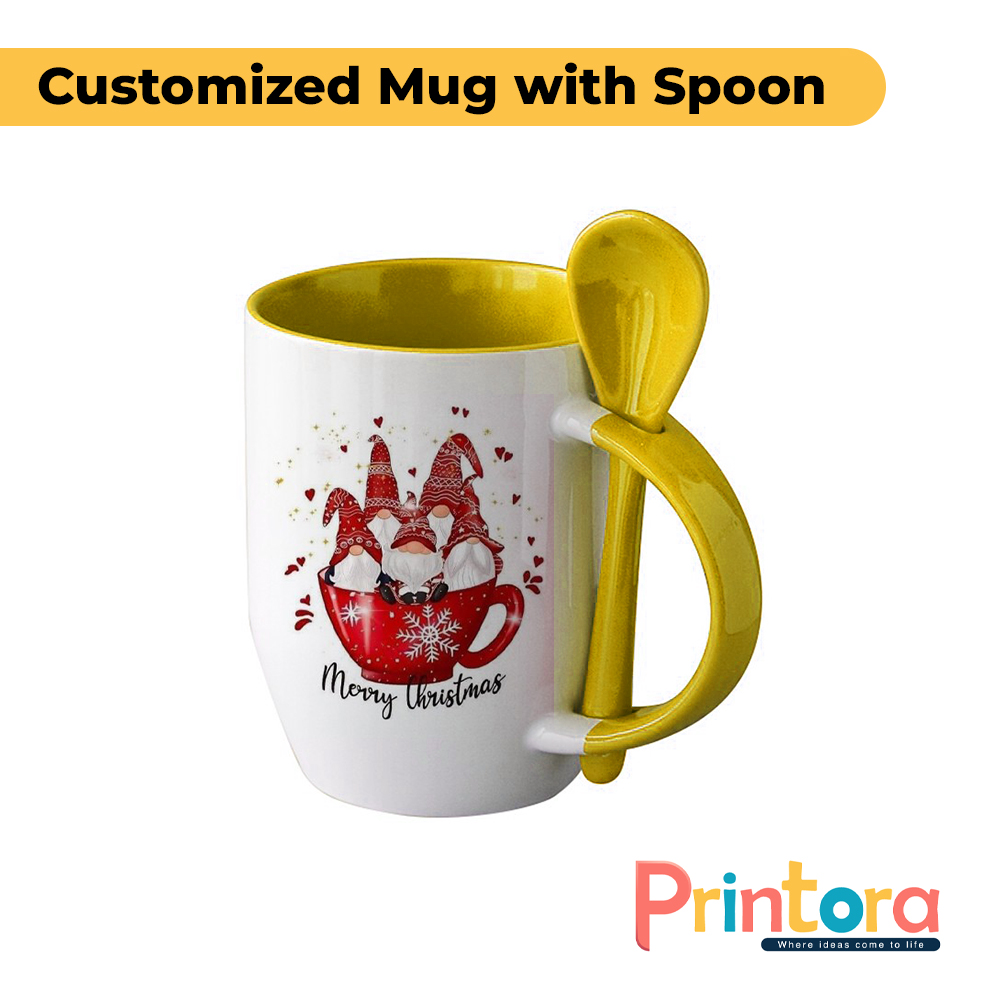 A white ceramic customized mug featuring a personalized photo print and a matching colored spoon inserted into the handle. The mug has a glossy finish and is designed for gifting and everyday use in Pakistan.