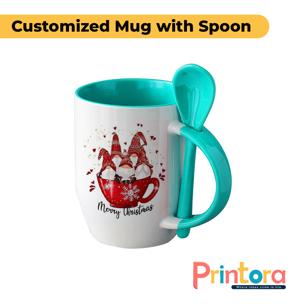 A white ceramic customized mug featuring a personalized photo print and a matching colored spoon inserted into the handle. The mug has a glossy finish and is designed for gifting and everyday use in Pakistan.